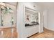 Welcoming foyer featuring hardwood floors, custom built-ins and natural light from a front door at 2411 Calais Pl, Charlotte, NC 28211