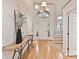 Bright foyer with a striking chandelier, high ceilings, wood floors, and an elegant front door at 2411 Calais Pl, Charlotte, NC 28211
