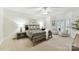 Comfortable main bedroom with a sitting area, neutral carpet, and ample natural light at 2411 Calais Pl, Charlotte, NC 28211