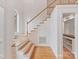 Elegant staircase showcasing hardwood steps and white banisters at 2411 Calais Pl, Charlotte, NC 28211