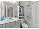 Well-lit bathroom features a toilet and tub with shelving and decorative items at 250 Kerri Dawn Ln, Locust, NC 28097