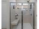 Modern tiled shower includes a glass door and a convenient built-in bench at 250 Kerri Dawn Ln, Locust, NC 28097