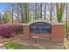 Stone sign for The Villages of Eastover Glen is surrounded by spring flowers and mature trees at 2500 Cranbrook Ln # 2, Charlotte, NC 28207