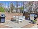 Brick-paved patio features outdoor kitchen, dining table, and professional grill for entertaining at 2500 Cranbrook Ln # 2, Charlotte, NC 28207