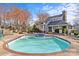 Resort-style swimming pool with a hot tub, lounge chairs, and community clubhouse in a picturesque setting at 2500 Cranbrook Ln # 2, Charlotte, NC 28207