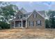 Charming two-story brick home featuring a covered front porch and classic architectural details at 2720 Old Course Rd, Monroe, NC 28112
