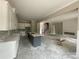 Spacious interior showcasing a gray island, white cabinets, fireplace and staircase under construction at 2720 Old Course Rd, Monroe, NC 28112