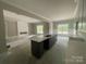 Bright living area with a modern gray island, beautiful countertops, and a decorative fireplace at 2720 Old Course Rd, Monroe, NC 28112