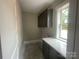 Practical mudroom featuring gray cabinets, counterspace, and a window for natural light at 2720 Old Course Rd, Monroe, NC 28112