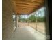 Covered back patio ready for outdoor entertaining with a view of the backyard at 2720 Old Course Rd, Monroe, NC 28112