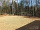 Backyard with seeded lawn, trees, and natural surroundings at 2739 Great Falls Hwy, Lancaster, SC 29720