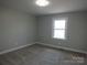 Bedroom offers neutral walls, carpet flooring, and a single window to let the sunshine in at 2739 Great Falls Hwy, Lancaster, SC 29720