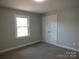 Bedroom boasts neutral walls, carpet flooring, and a single window and closet at 2739 Great Falls Hwy, Lancaster, SC 29720