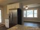 Bright kitchen with stainless steel refrigerator, granite counters, white cabinets, and seamless flow into the adjacent living area at 2739 Great Falls Hwy, Lancaster, SC 29720