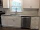 Updated kitchen with stainless steel appliances, granite countertops, white cabinets, and a modern sink at 2739 Great Falls Hwy, Lancaster, SC 29720