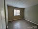 Bedroom with a window overlooking the front yard and a standard closet at 300 Orchard Trace Ln # 3, Charlotte, NC 28213