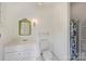 Bright bathroom featuring white fixtures, tiled floors, and a shower with a patterned curtain at 318 S Canterbury Rd, Charlotte, NC 28211