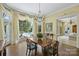 Bright dining room featuring herringbone floors, chandelier, and a large window overlooking the pool at 318 S Canterbury Rd, Charlotte, NC 28211