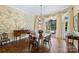 Dining room with chandelier, natural light, and decorative wallpaper at 318 S Canterbury Rd, Charlotte, NC 28211