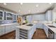 Spacious kitchen with blue cabinets, white countertops, stainless steel appliances, and tile backsplash at 318 S Canterbury Rd, Charlotte, NC 28211