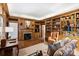 Cozy wood paneled library with a fireplace, built-in bookshelves, and comfortable seating at 318 S Canterbury Rd, Charlotte, NC 28211