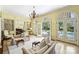 Bright living room featuring arched windows/doorways and a view of the outdoor pool and patio area at 318 S Canterbury Rd, Charlotte, NC 28211