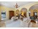 Bright living room with arched doorways, columns, hardwood floors, and an elegant chandelier at 318 S Canterbury Rd, Charlotte, NC 28211