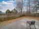 A spacious backyard featuring a concrete patio, privacy fence, and leafy groundcover at 3253 Ian Patrick Ave, Kannapolis, NC 28083