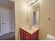 Bathroom featuring a single sink vanity, large mirror, and an adjacent room at 3253 Ian Patrick Ave, Kannapolis, NC 28083