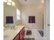 Well-lit bathroom with double sink vanity, tile flooring, and enclosed shower at 3253 Ian Patrick Ave, Kannapolis, NC 28083