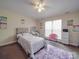 Bright bedroom with a ceiling fan and natural light from a window, complemented by soft carpeting at 3253 Ian Patrick Ave, Kannapolis, NC 28083