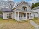 Inviting home with a quaint front porch, solar panels, and well-kept lawn at 3253 Ian Patrick Ave, Kannapolis, NC 28083