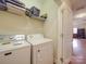 Bright laundry room with washer, dryer, and ample shelving for storage and a door leading to another room at 3253 Ian Patrick Ave, Kannapolis, NC 28083