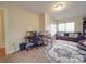 Cozy living room features tile flooring, a comfortable sofa, and ample natural light from a large window at 3253 Ian Patrick Ave, Kannapolis, NC 28083