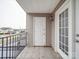 Small outdoor patio area featuring a tiled floor, wrought iron fence, and storm door at 3253 Ian Patrick Ave, Kannapolis, NC 28083