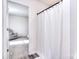 View into the bathroom, showcasing a white shower curtain and access to another bedroom at 345 Corinth Church Rd, Mooresville, NC 28115