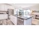 Bright kitchen features an island with granite counters, stainless steel appliances, and white cabinets at 345 Corinth Church Rd, Mooresville, NC 28115