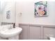 Stylish half bath with modern fixtures, wainscoting, and decorative artwork for a touch of elegance at 345 Corinth Church Rd, Mooresville, NC 28115