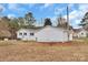 Rear exterior view of freshly painted white single-story home with a detached garage in back at 356 Hill Rd, Lincolnton, NC 28092