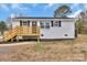 Charming white brick home with a new wooden porch and black shutters at 356 Hill Rd, Lincolnton, NC 28092