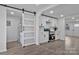 Updated kitchen with stainless steel appliances, white cabinets, and a sliding barn door with glass inserts at 356 Hill Rd, Lincolnton, NC 28092