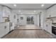 Bright kitchen features white cabinetry, stainless appliances, eat-in nook, and a sliding barn door to another room at 356 Hill Rd, Lincolnton, NC 28092