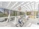 Relaxing screened-in porch area with white wood and two hanging chandeliers at 3601 Rosedown Dr, Matthews, NC 28105