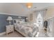 Bedroom featuring a blue accent wall, patterned bedding and a woven light fixture at 3601 Rosedown Dr, Matthews, NC 28105