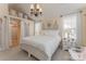 Bright bedroom features neutral walls, light wood flooring and an elegant chandelier at 3601 Rosedown Dr, Matthews, NC 28105