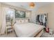 Bedroom featuring a bed, and nearby windows offering natural light and a clothing rack at 3601 Rosedown Dr, Matthews, NC 28105