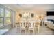 Bright dining room features wood table, white chairs, stylish decor and plenty of natural light at 3601 Rosedown Dr, Matthews, NC 28105