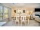 Bright dining room features wood table, white chairs, stylish decor and plenty of natural light at 3601 Rosedown Dr, Matthews, NC 28105