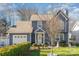 Charming two-story home with blue siding, manicured lawn, and attached garage in a desirable neighborhood at 3601 Rosedown Dr, Matthews, NC 28105