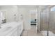 Bathroom with dual sinks, a shower, and an open doorway to the bedroom at 367 Kennerly Center Dr, Mooresville, NC 28115